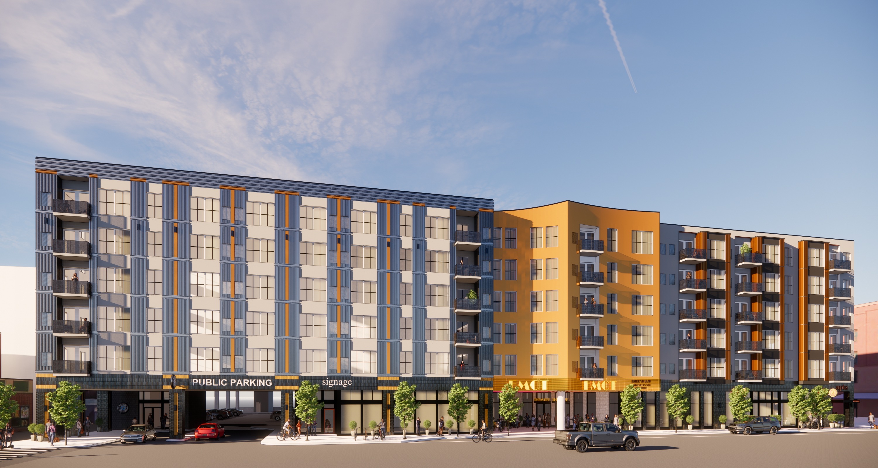A modern multi-story building with a parking lot in front.